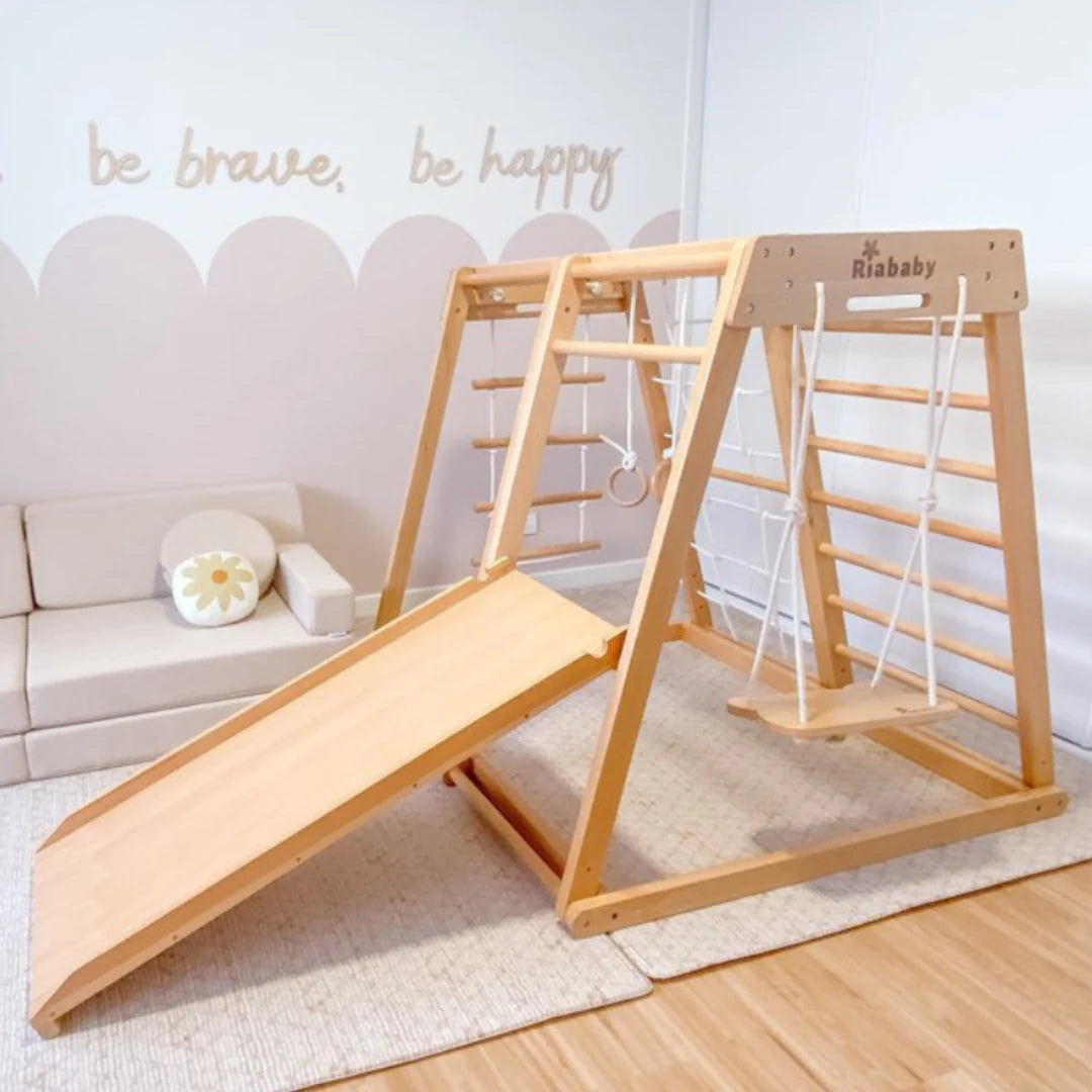 Kangaroo wooden climbing playhouse with slide, swing, gym rings and soft ladder in a home playroom