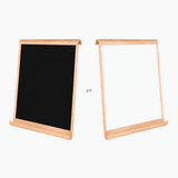 Double-sided magnetic drawing board showing the black chalkboard side and whiteboard side
