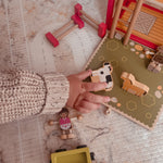 Child playing with wooden farm animals and figures from the Farm House GoBox