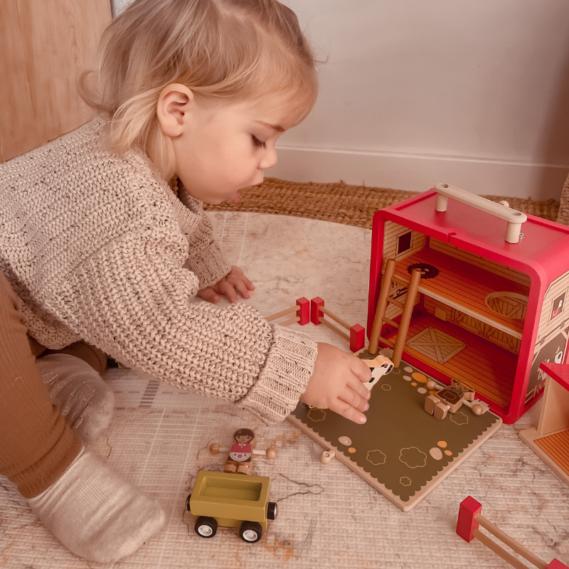 Child playing with the Wooden Farm House GoBox, farm animals and tractor