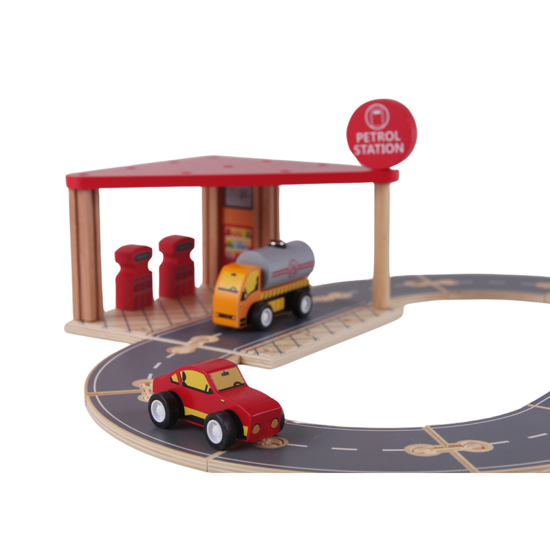 Wooden Petrol Station arranged as a road play scene with cars, pumps and connected track pieces