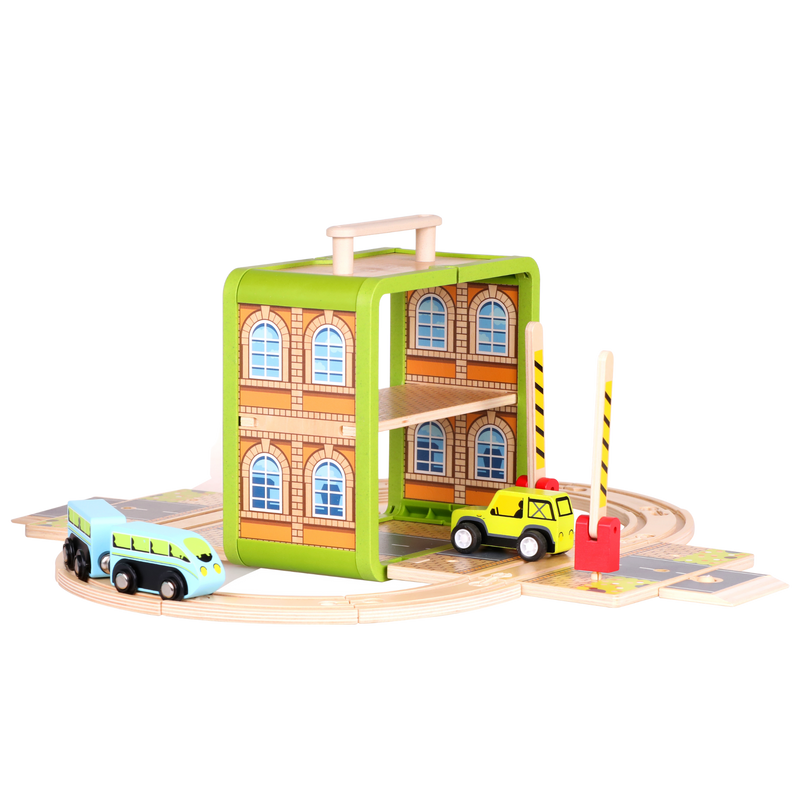 Wooden Train Set arranged as a railway scene with station, tracks and train carriages