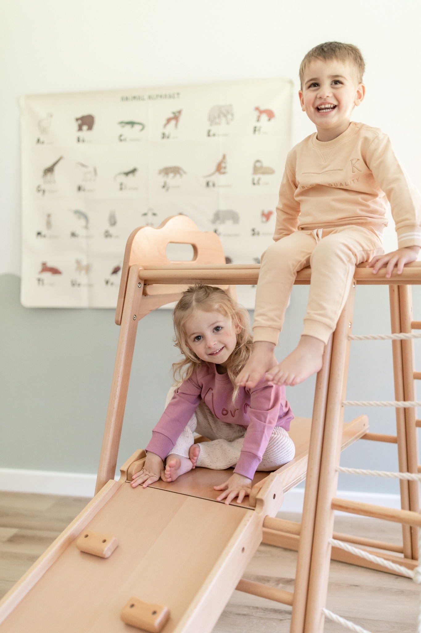 Children exploring the Koala Playhouse slide and climbing frame