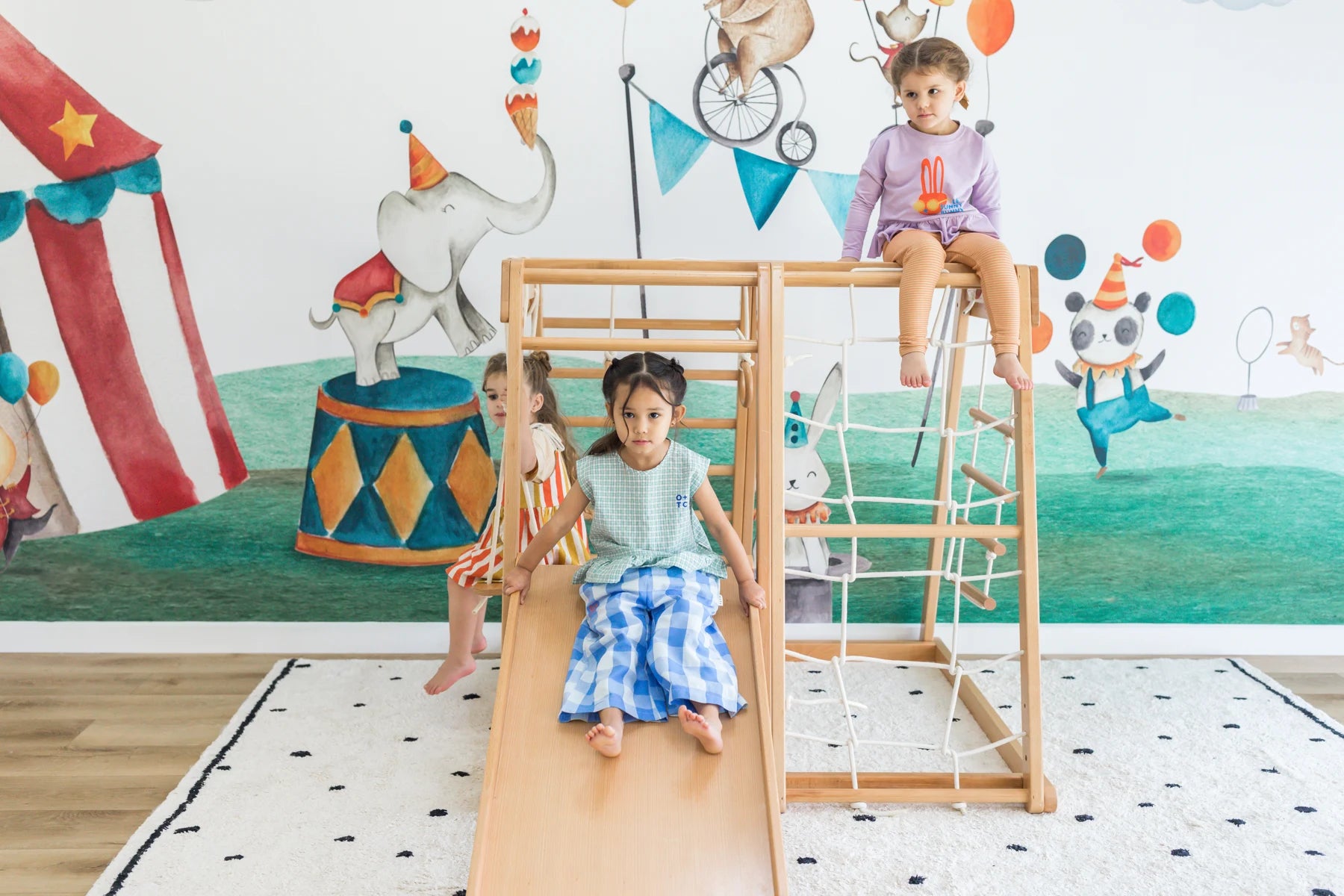 Children playing together on the Kangaroo wooden climbing playhouse