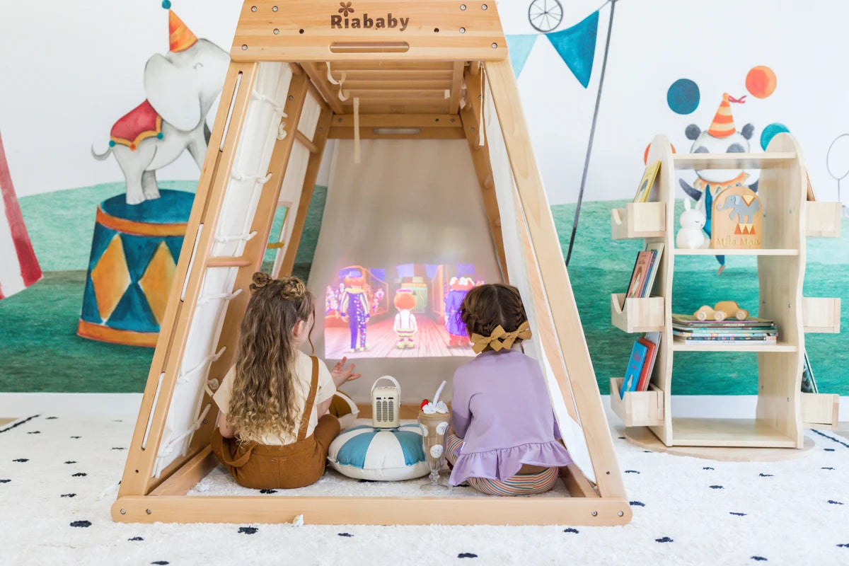A child playing inside a bright Riababy climbing playhouse with a glamping tent