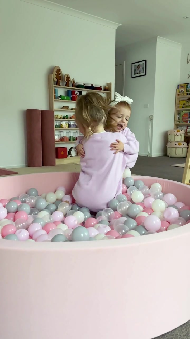 Two children playing in the pink 130cm round ball pit